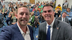 State Superintendent Ryan Walters and Gov. Kevin Stitt post for a selfie in Sept. 2023.