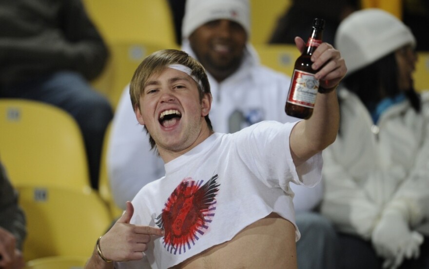 A soccer fan drinks beer before a 2010 World Cup soccer game in South Africa. Budweiser has been the official beer of the FIFA World Cup since 1986 — a role at odds with 2014 World Cup host Brazil's ban on beer at games.