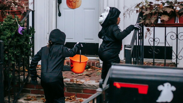 Trick-or-treaters go door to door on Halloween.