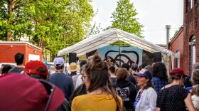 Audience members watch an outdoor performance at a past Thing in the Spring