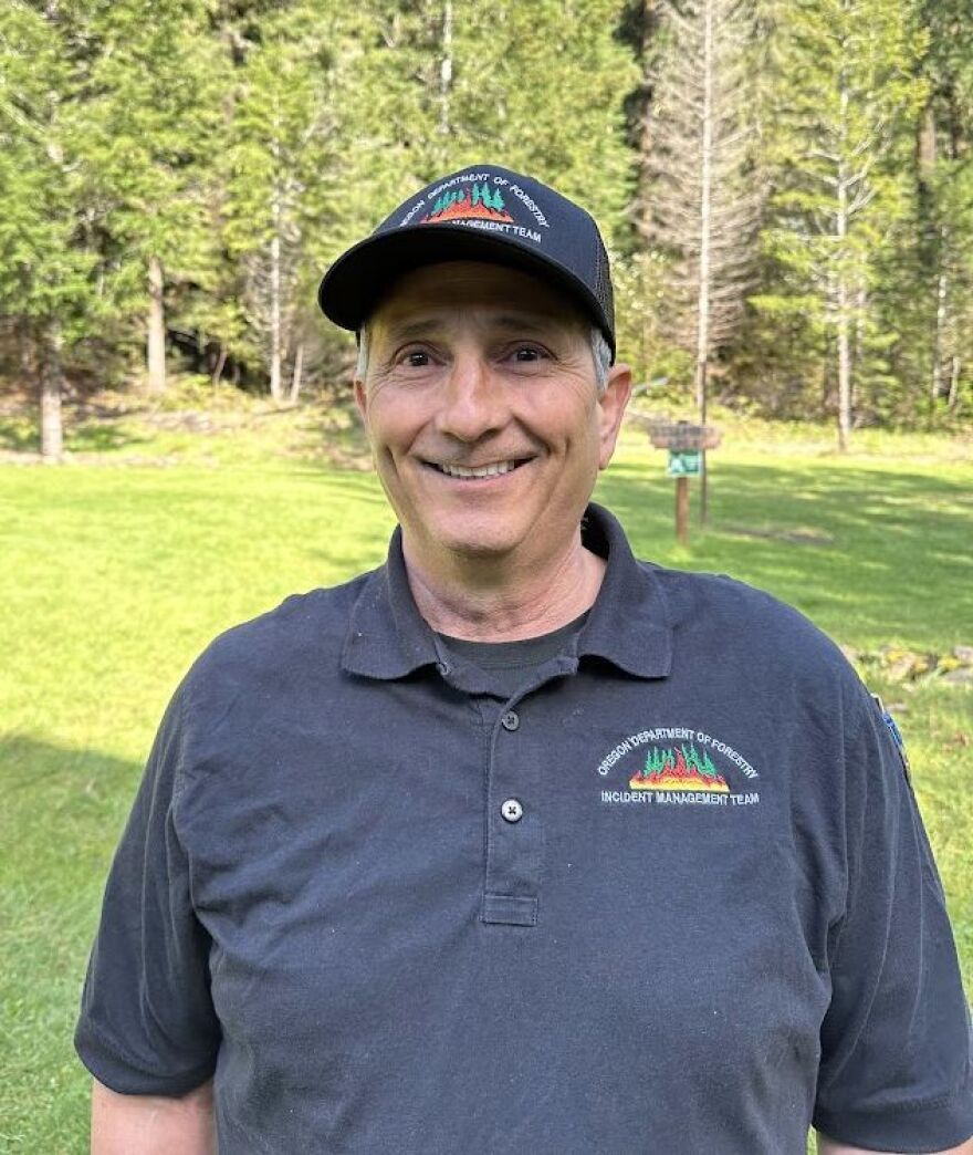 Forest official near woods.