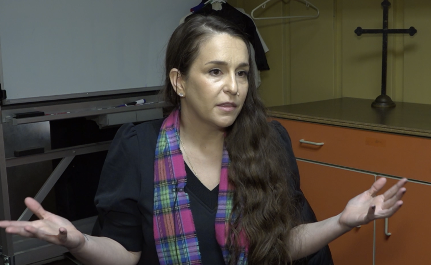 The parent of a Medicaid recipient is interviewed after a conversation with former US Senator Sherrod Brown (D).