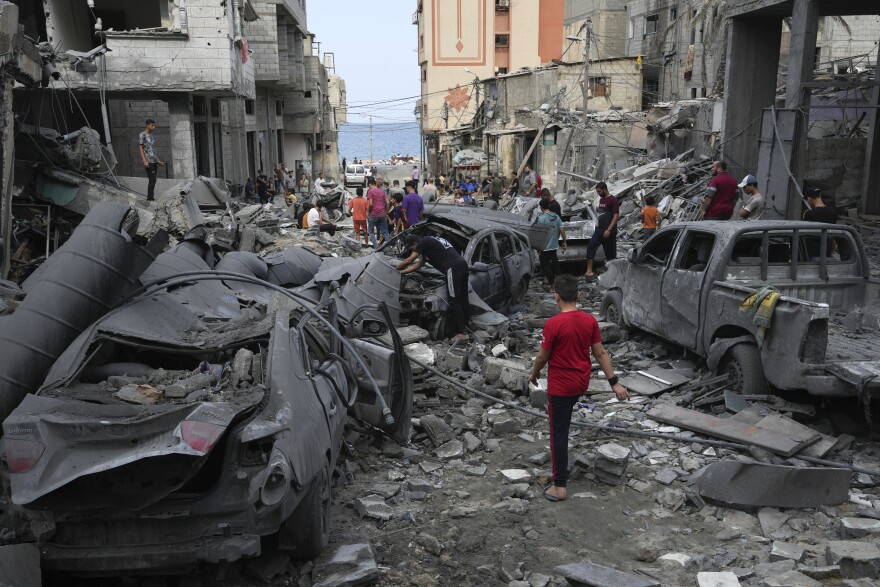 Palestinians inspect the rubble of the West mosque destroyed after it was hit by an Israeli airstrike at Shati refugee camp in Gaza City, early Monday, Oct. 9, 2023. Israel's military battled to drive Hamas fighters out of southern towns and seal its borders Monday, as it pounded the Gaza Strip from the (AP Photo/Adel Hana)