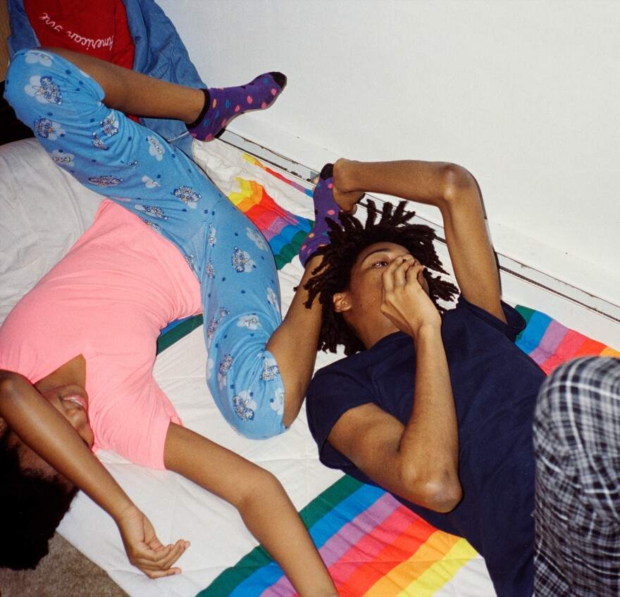 Thandi and Khaya lying down in their pajamas.