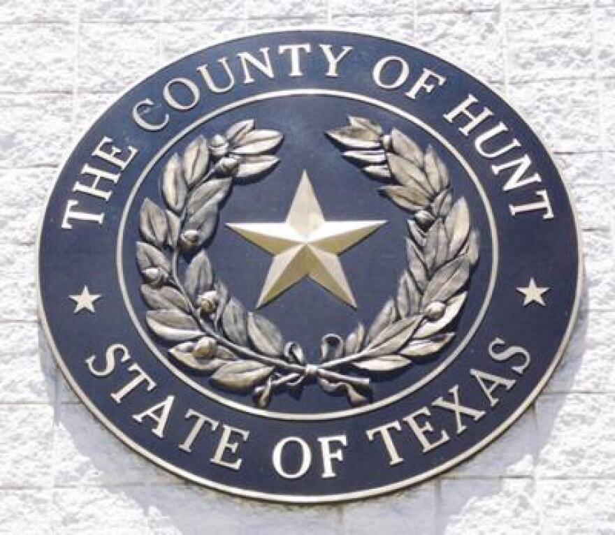 The seal of Hunt County hangs from the county courthouse wall.