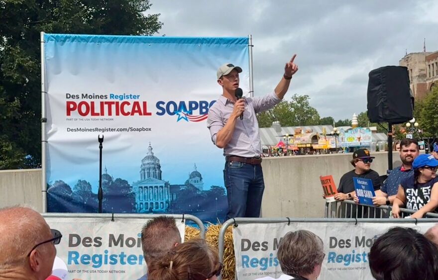 Democrat Rob Sand speaks at the 2026 Iowa State Fair. (Sheila Brummer, IPR)