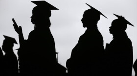 In this May 17, 2018, file photo, new graduates line up before the start of the Bergen Community College commencement at MetLife Stadium in East Rutherford, N.J. Obtaining a college degree has increasingly coincided with ever-higher student debt loads. Since 2004, total student debt has climbed more than 540 percent to $1.4 trillion, according to the New York Federal Reserve. (Seth Wenig, File/AP)