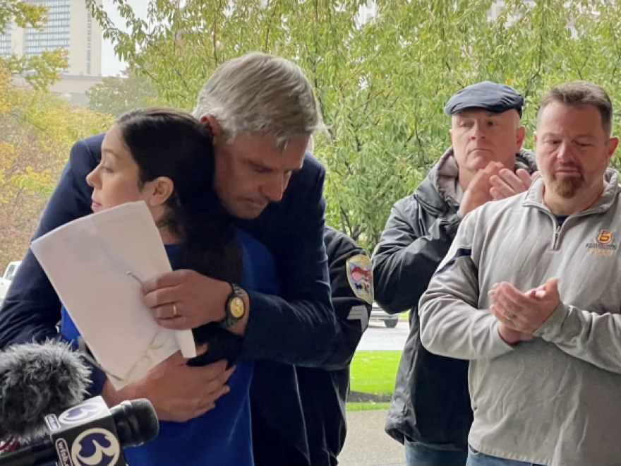 Bob Stefanowski hugs Kris O'Donnell, the wife of an injured Farmington police officer.