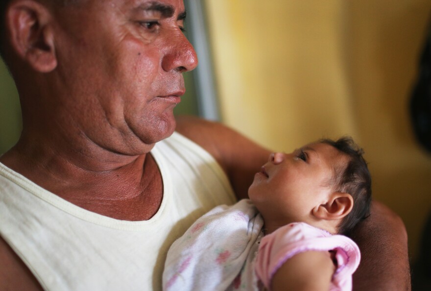 This 3-month-old baby, born with microcephaly, is held by her father in Recife, Brazil.