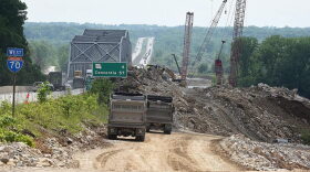  Construction workers haul limestone quarried from the river bluff to the construction site of a new Interstate 70 Missouri River bridge connecting Boone and Cooper counties. 