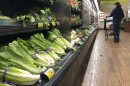 Romaine Lettuce still sits on the shelves as a shopper walks through the produce area of an Albertsons market Tuesday, Nov. 20, 2018, in Simi Valley, Calif. Health officials in the U.S. and Canada told people Tuesday to stop eating romaine lettuce because of a new E. coli outbreak.