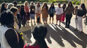 FILE - Supporters of a lawsuit challenging a Hawaii midwife licensure law gather outside a courthouse in Honolulu, June 10, 2024. On Monday, July 22, a Hawaiʻi judge temporarily blocked the state from enforcing a licensure law against those who practice and teach traditional Native Hawaiian midwifery. (AP Photo/Jennifer Sinco Kelleher, File)