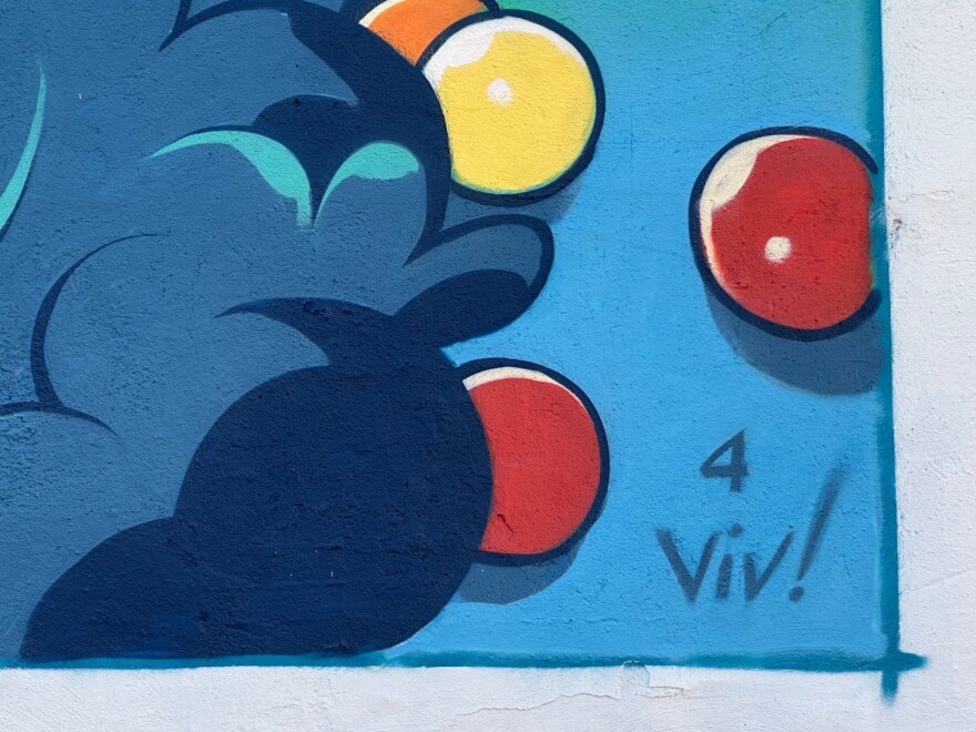 A border of artwork on Chris Murray's mural at Clinton and West Lafayette Streets is attributed to his daughter. It is his signature that reads, "4 Viv!" in blue paint over bursts of blue, red, orange and yellow balloons.