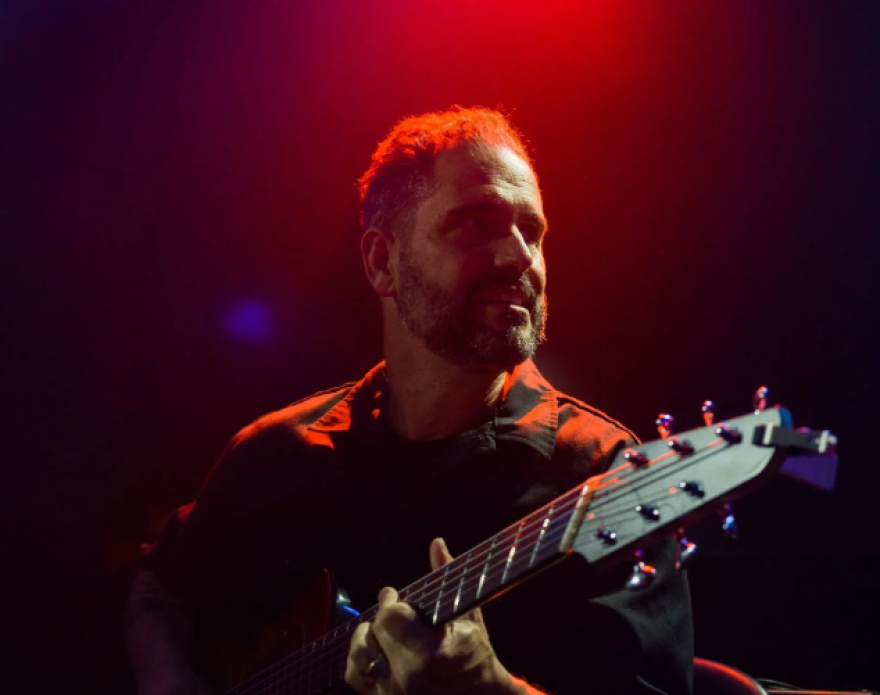 Charlie Hunter playing a guitar.