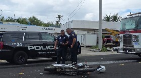 Sgt. Adrian Mendiola talks with a fellow DPS officer Thursday as investigators worked the scene of the fatal motorcycle crash.
