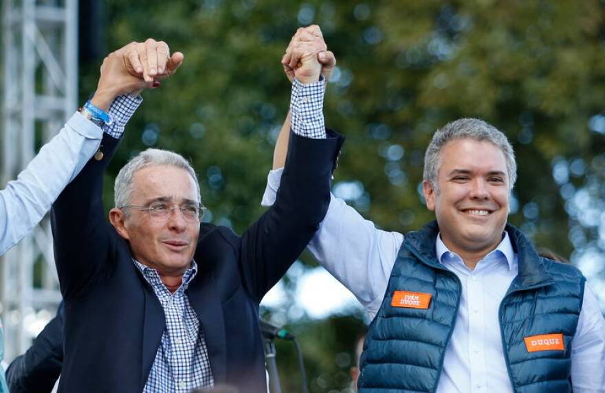PLIABLE PROTEGE? Colombian President-elect Ivan Duque (right) on the campaign trail with former President Alvaro Uribe in May.