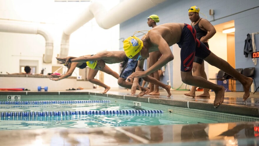 Rocket McDonald (front) and Makos Swim teammates enter the water without starting blocks during practice at the YMCA’s O’Fallon Park Rec Complex on March 18, 2025, in St. Louis.