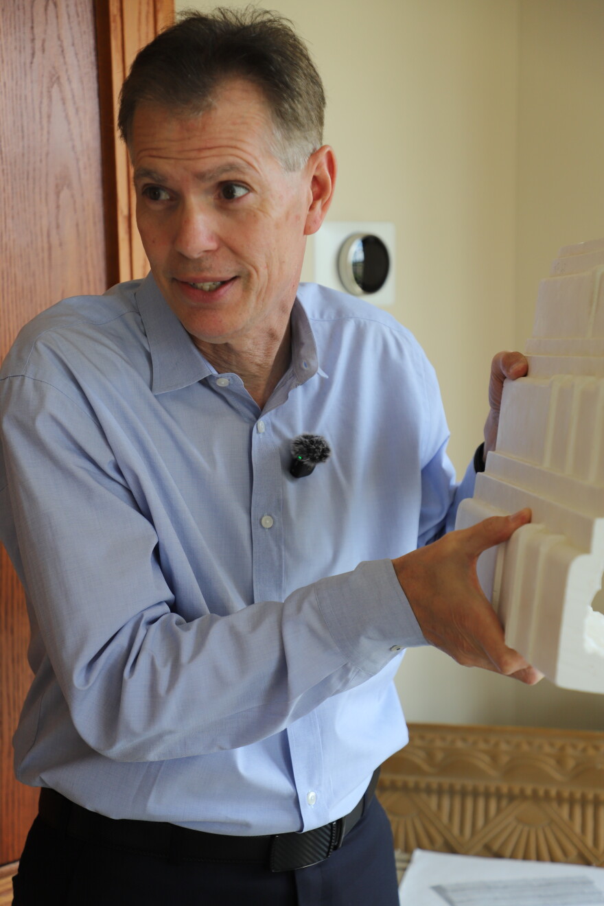 Owner Randy Theken holds up a sample of the plaster that decorates the ceiling on the first floor of the terminal. After finding the company that made the original plaster molds, he had them recreated and then hired a father-son duo from New York to seamlessly install the new plaster — a task that took a year to complete.