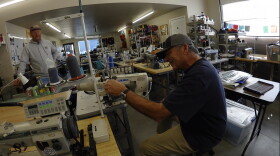 Erik Dalton loos on as as Kurt Gray explains a sewing machine