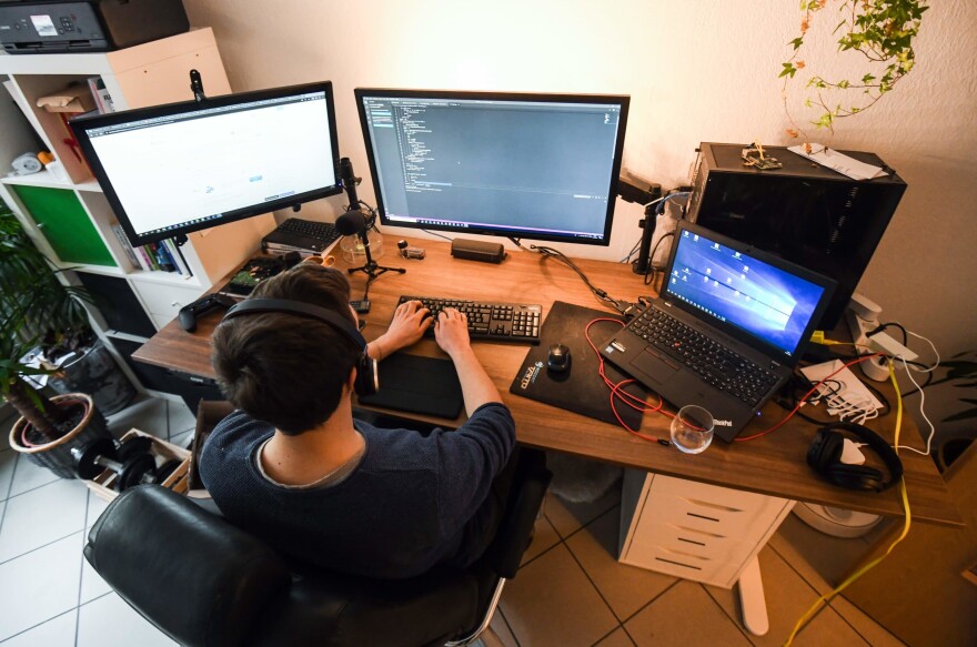 A computer scientist works in his home office  (Ina Fassbender/AFP via Getty Images)