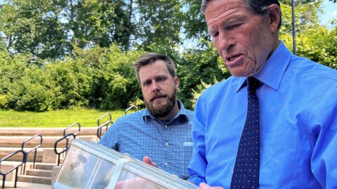 Connecticut U.S. Sen. Richard Blumenthal (right) and Connecticut state entomologist Jacob Ricker examine a box containing live spotted lanternflies before a press conference in East Hartford, Aug. 10, 2026. The bugs are invasive and can damage crops and forests.