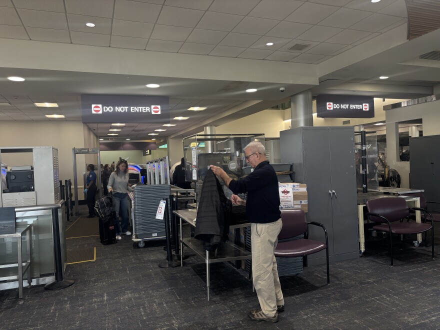 Travelers passing through TSA at Albany International Airport