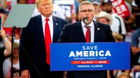 Illinois State Rep. Darren Bailey (R-Xenia) speaks next to former President Donald Trump, who endorsed Bailey for Illinois’ gubernatorial race, on Saturday, June 25, 2022, during a “Save America!” Rally at the Adams County Fairgrounds in Mendon, Ill.