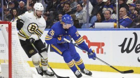 Buffalo Sabres defenseman Rasmus Dahlin (26) carries the puck around the net past Boston Bruins center Pavel Zacha (18) during the second period of an NHL hockey game, Tuesday, Nov. 14, 2023, in Buffalo N.Y. (AP Photo/Jeffrey T. Barnes)