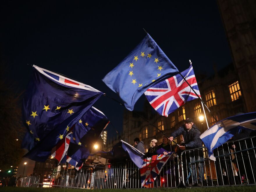 Anti-Brexit campaigners wave the Union Jack and European Union flags outside the Houses of Parliament on Wednesday.