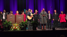 Members of Martin Luther King Jr. Commission of Mid-Michigan sing We Shall Overcome