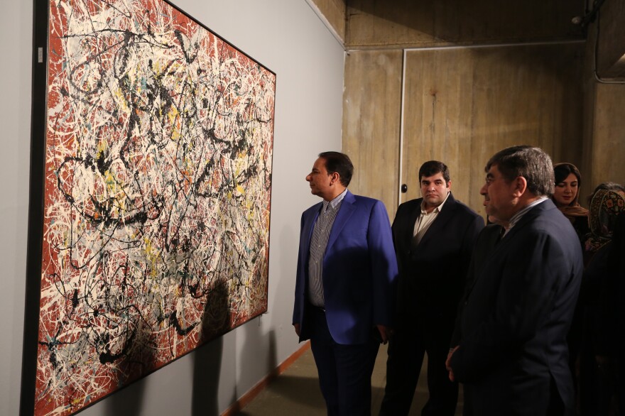 Iranian Culture Minister Ali Jannati (right) looks at Jackson Pollock's "Mural on Indian Red Ground" (1950) during the opening ceremony of an exhibition at Tehran's Museum of Contemporary Art on Nov. 20.