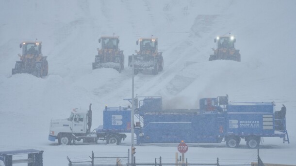 Airport crew plow snow during a winter storm in Philadelphia, Sunday, Jan. 25, 2026.