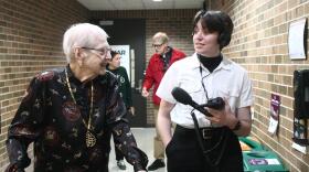 Leora Stutes (left) walks with WKAR reporter Emma J Nelson (right) during a tour of the WKAR TV and radio studios Thursday, May 21, 2026.