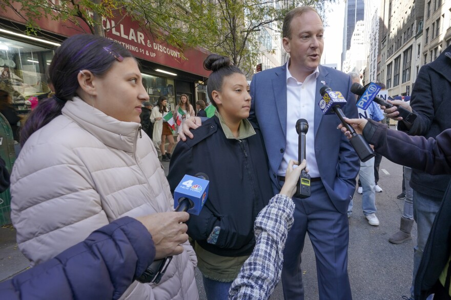 Republican candidate for New York Governor Congressman Lee Zeldin, right, stands with his daughters Arianna, center, and Mikayla, left, as he speaks to reporters before marching in the annual Columbus Day Parade, Monday, Oct. 10, 2022, in New York.