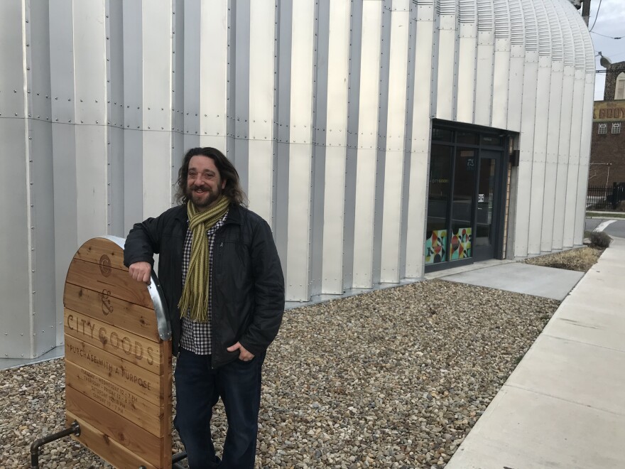 City Goods owner Sam Friedman stands outside one of the hangers