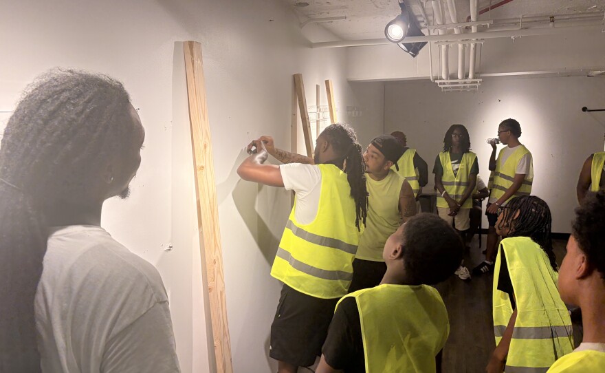 Handyman Academy instructors show students how to mount a TV.