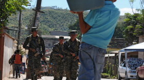 Honduran soldiers patrol poor neighborhoods in the outskirts of Tegucigalpa due to a deterioration of the police force.