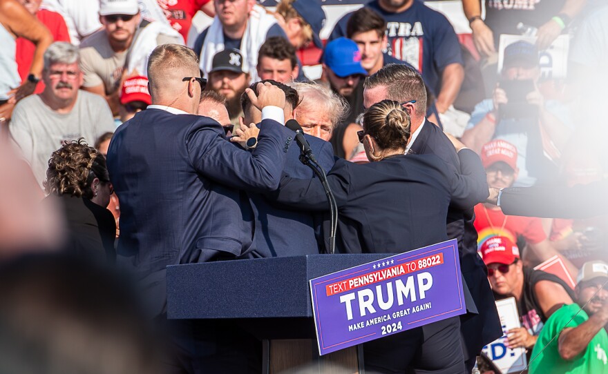 FILE - The Secret Service immediately surround former President Trump after he was shot during his campaign stop at the Butler Farm Show grounds on Saturday, July 13, 2024. (Ralph LoVuolo / Special to the Butler Eagle)