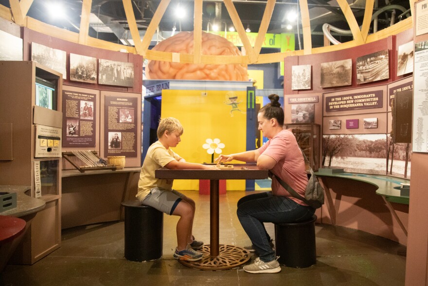 Noah Froehbrodt, 10, of North Carolina, plays checkers with his aunt, Sarah Froehbrodt, of Reading, at the Bloomsburg Children's Museum.