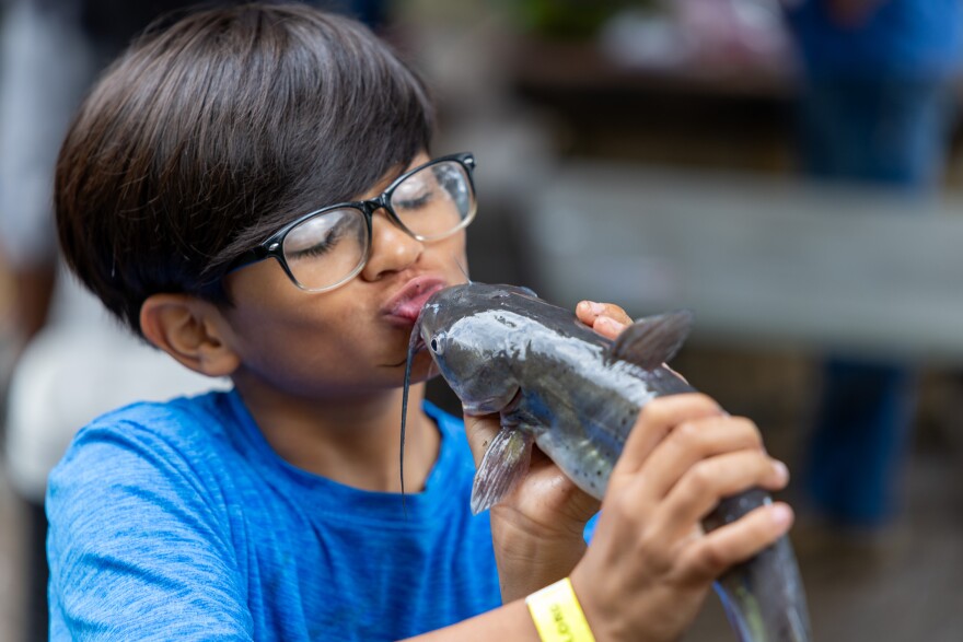 Young boy with his catfish catch at a fall fishing event at the park last year