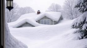 Photo of a house half-covered in snow from the blizzard of March 2026