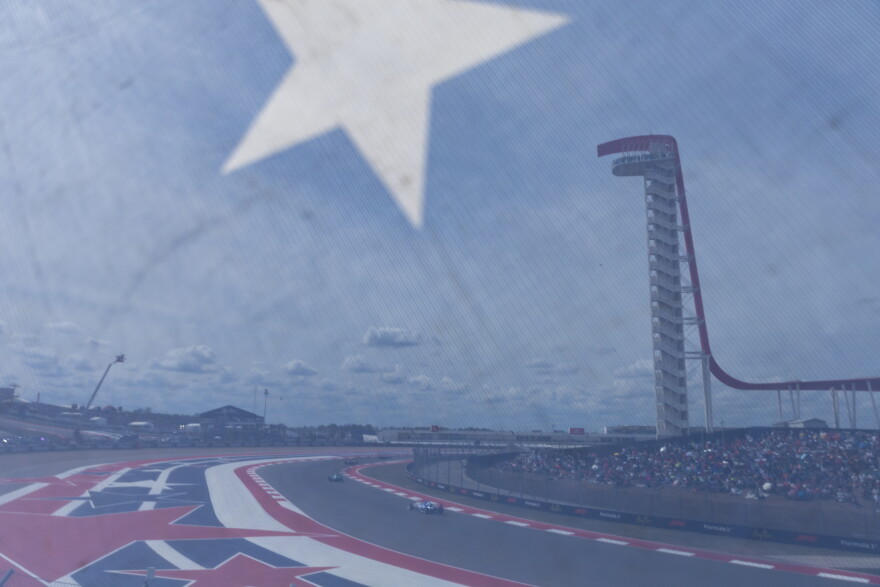 Seen through a stairway cover, F1 Academy drivers race at the United States Grand Prix at the Circuit of the Americas on Sunday.