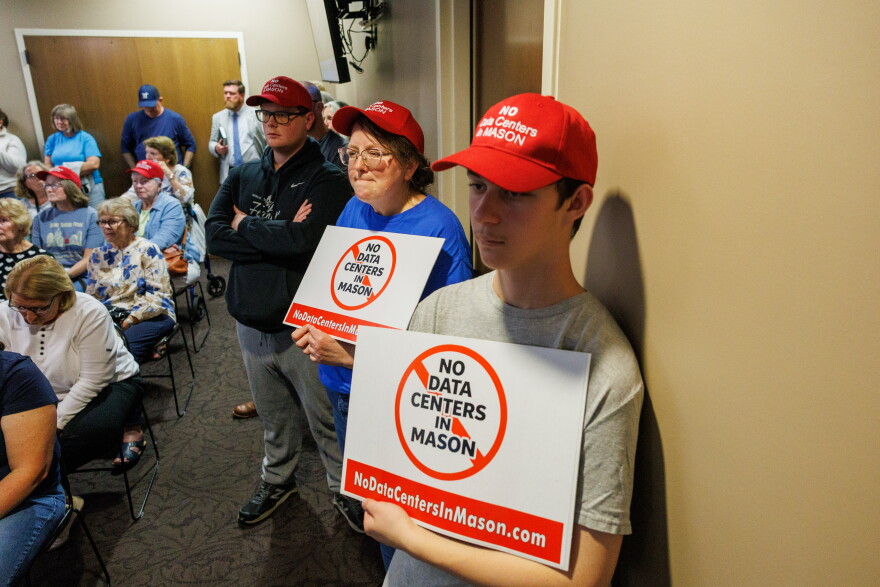 Community members opposing potential data center developments in Mason, Mich., wear custom red hats while attending a Mason City Council meeting and town hall on Sept. 14, 2026.