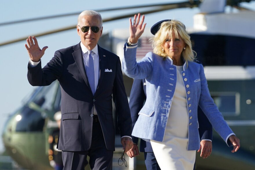 President Joe Biden and first lady Jill Biden wave walking in front of a helicopter and walking to board Air Force One.