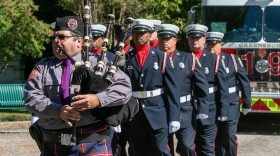 Bagpiper marching with firefighters
