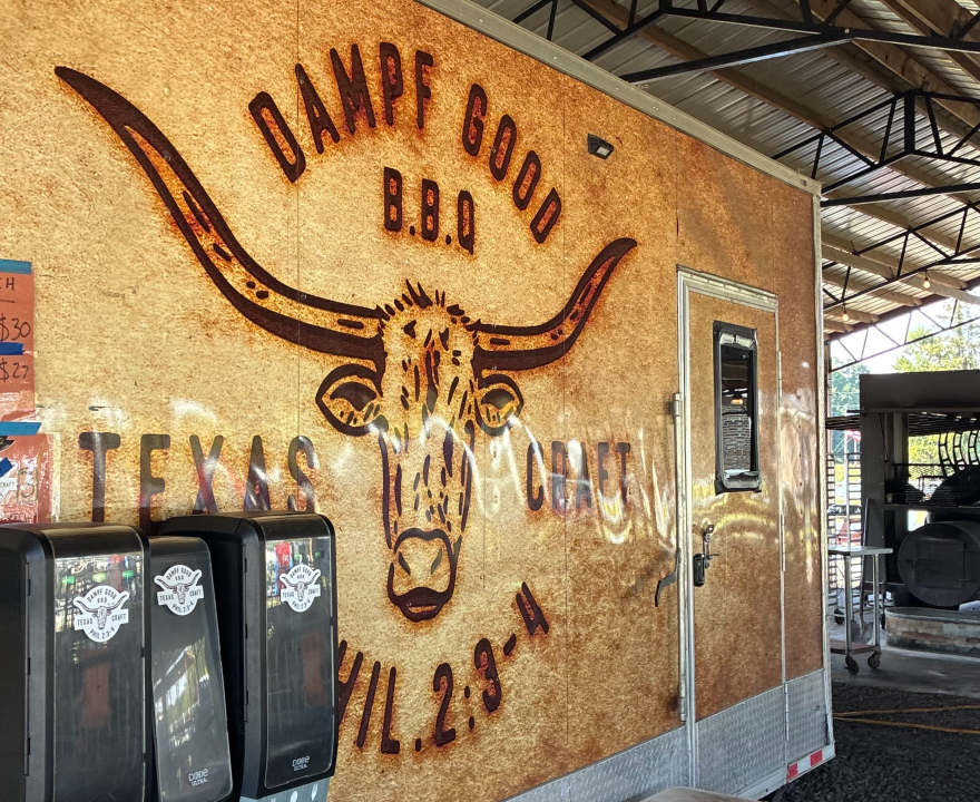 The side of a food truck with a longhorn logo