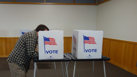 A voter casts their ballots in Bethel's municipal election and REAA election at the Yupiit Picaryarait Cultural Center in Bethel on Oct. 6, 2026.