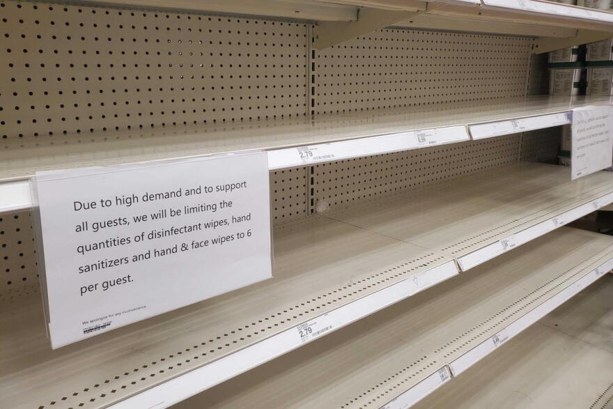 Shelves sit empty at a Target in the Indianapolis area with signs informing customers of limits on the number of products they can buy at a time.