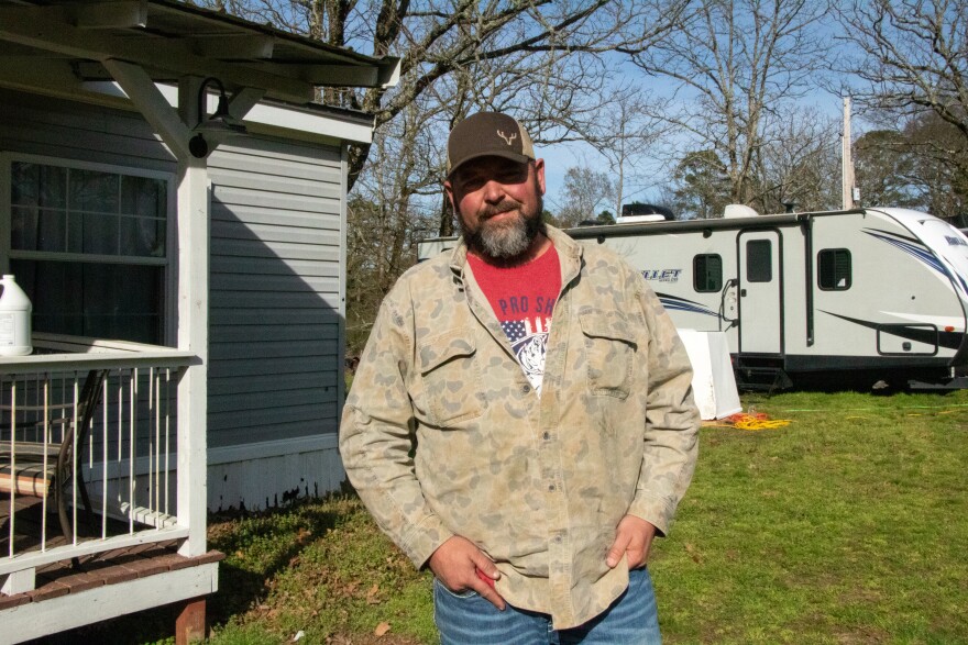 Eric Roath stands outside his home in Bethel.