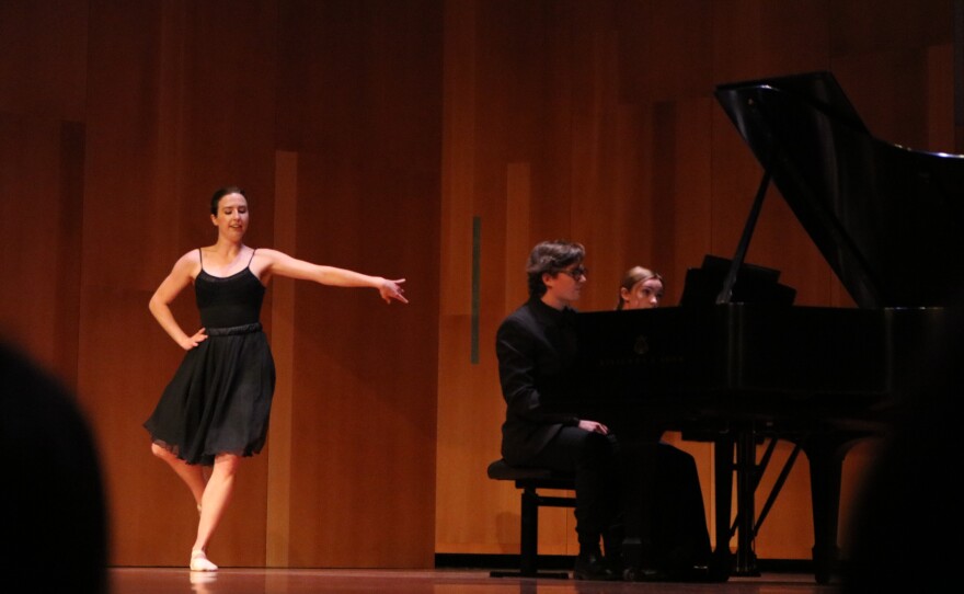 Susanna Russell dances while Jessie Evans and Lewis Wilhelm assist her on the piano.